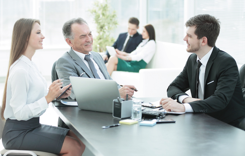 client talking with the staff at the Desk in the office