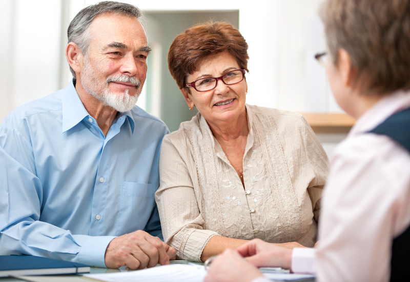 middle aged couple meeting with financial advisor