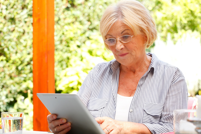 woman looking at finances on tablet