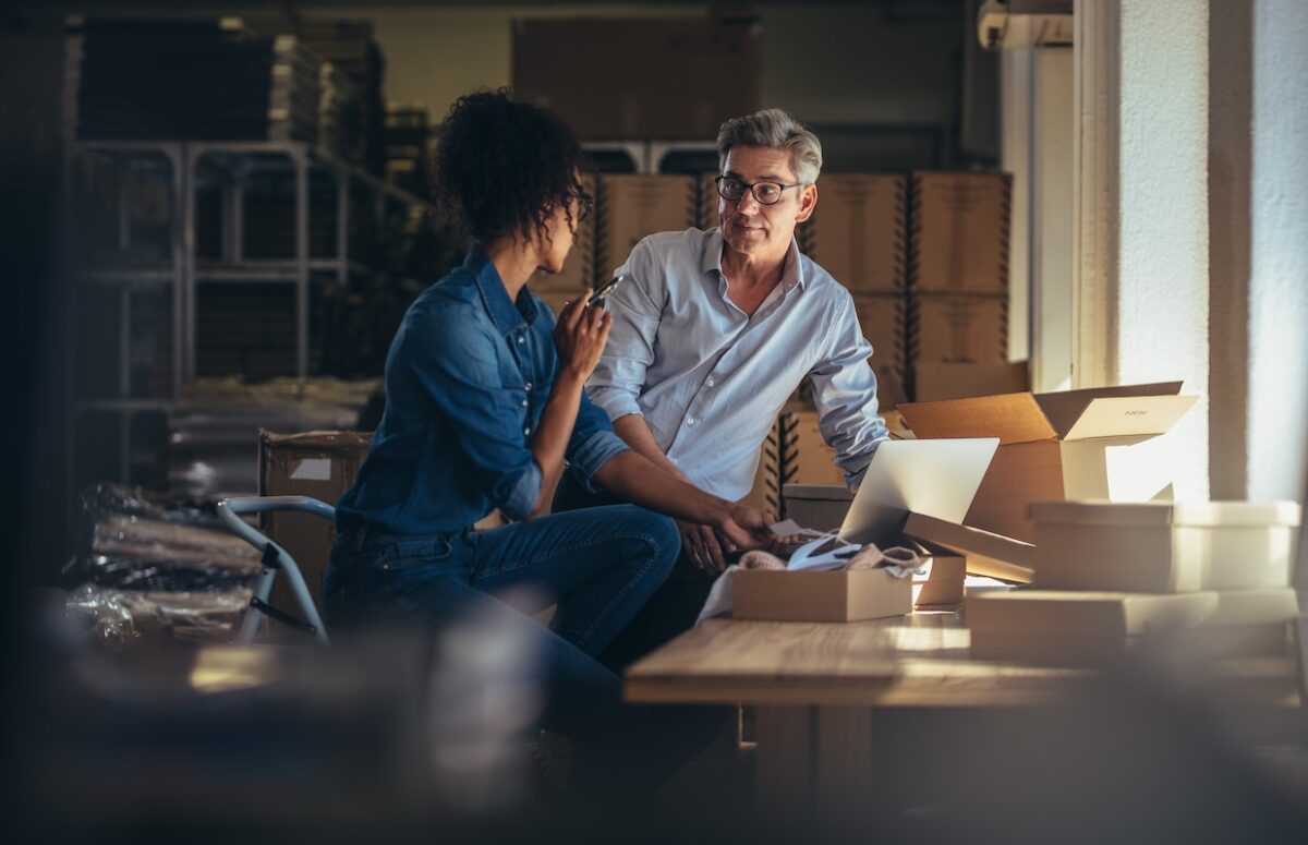 Small business owners discussing how to value their family business before selling, reviewing financial documents and preparing for succession planning.