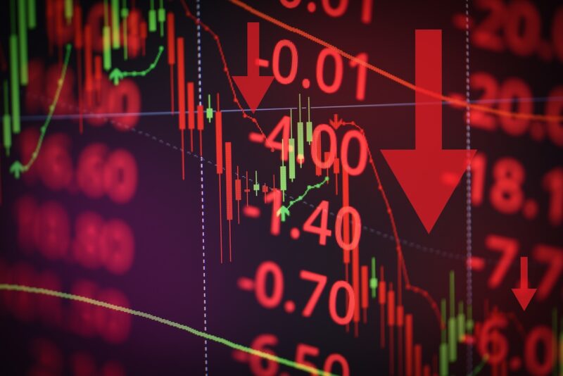 Stock market screen showing steep financial losses with red downward arrows and negative percentages, illustrating financial risk during a market downturn.