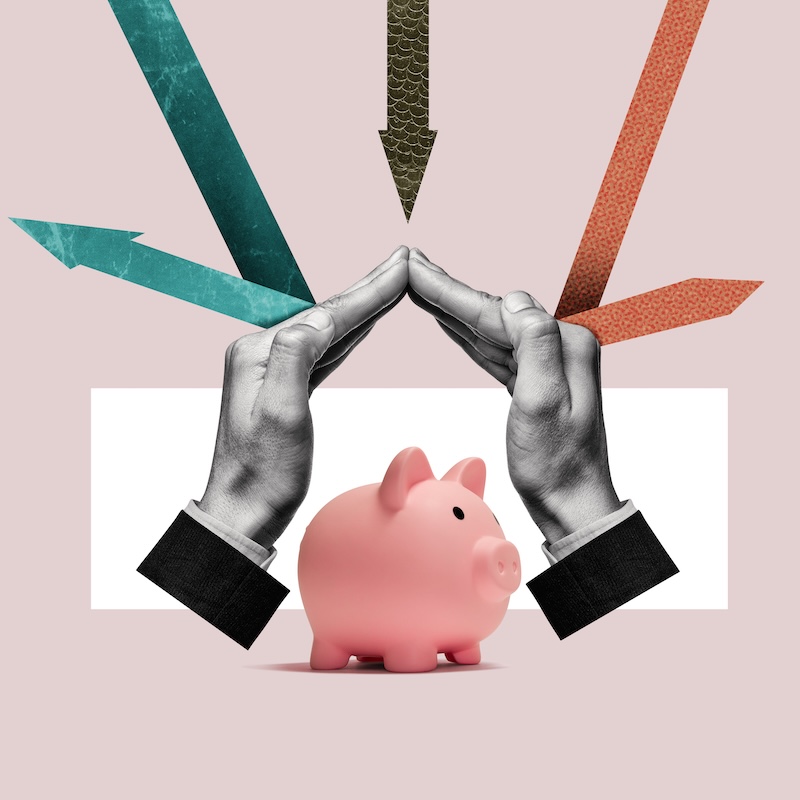 Hands shielding a piggy bank from incoming arrows, representing wealth risk management through diversification, insurance, and asset protection planning with a Buffalo Grove, IL financial advisor.
